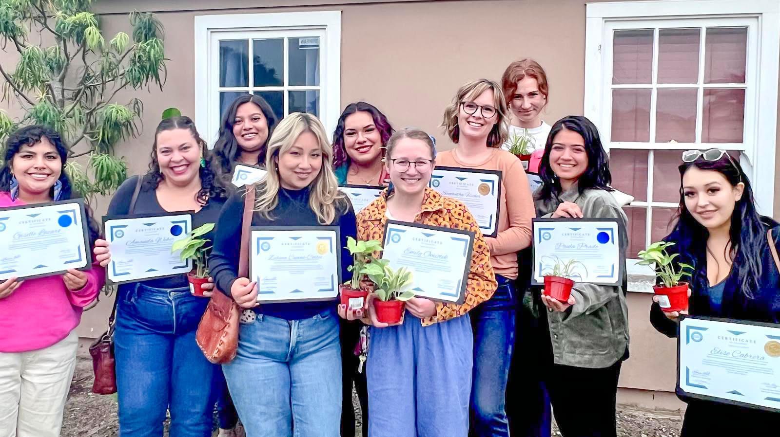Group of females holding up certificate